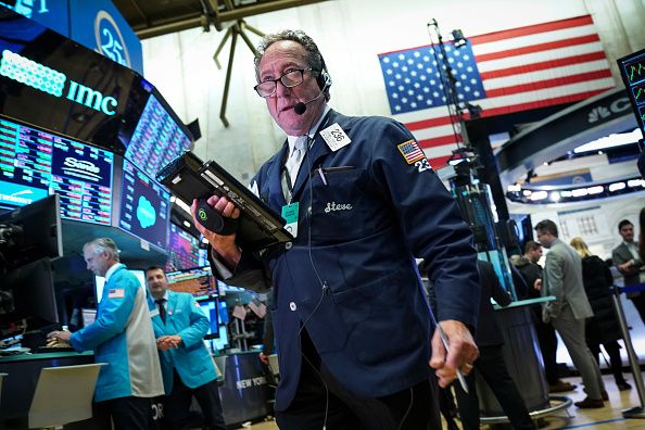 Stocks tumble on Fed warning, gold shines, oil slides