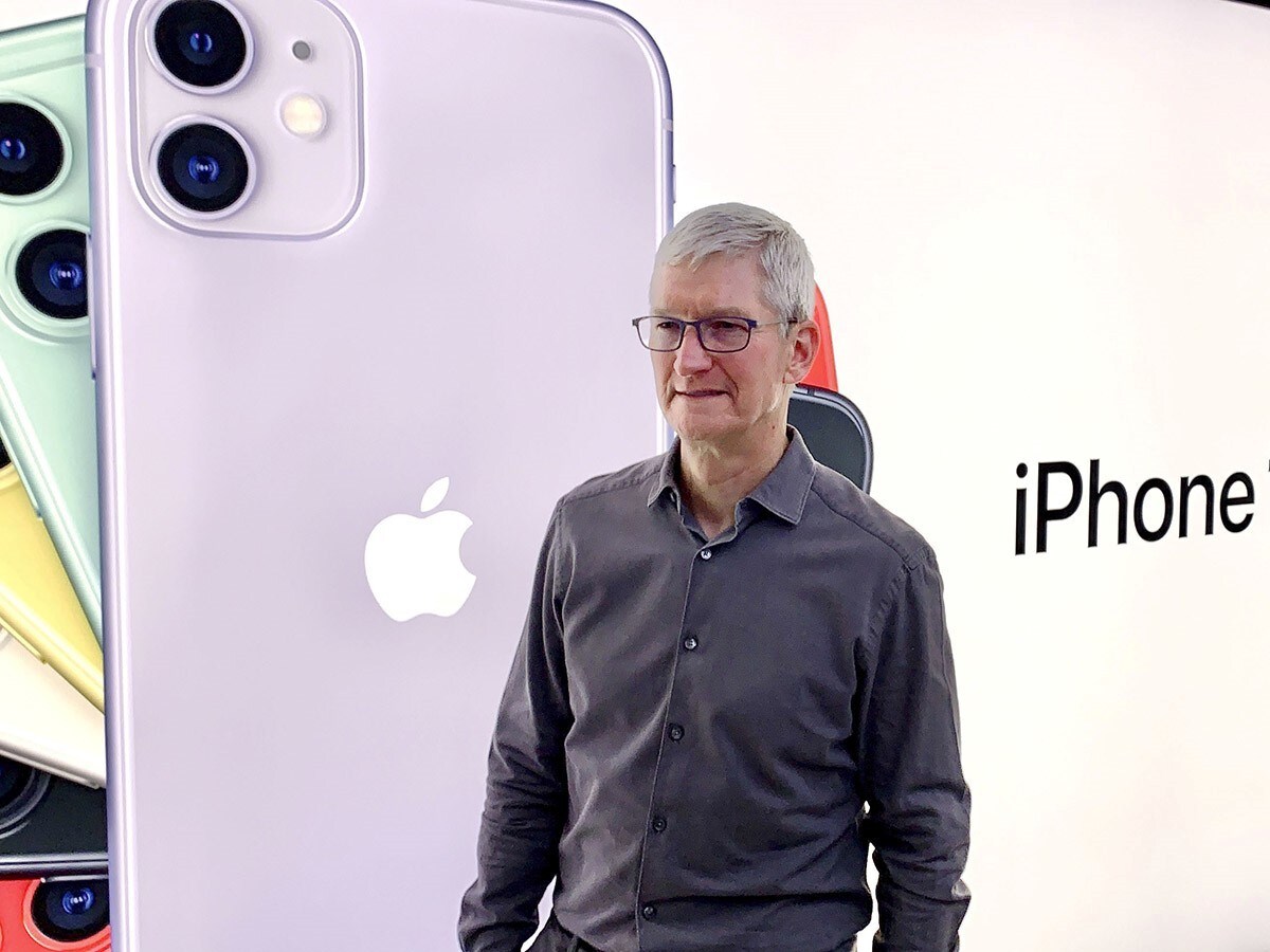 Apple share price: Tim Cook, Apple's CEO next to an iPhone ad