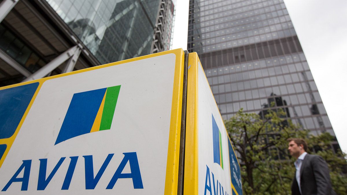 Aviva share price: a pedestrian walks past Aviva's offices.