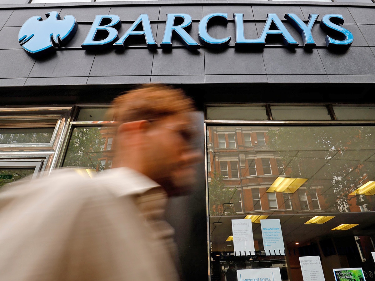 Barclays share price: a man walks past a branch of Barclays