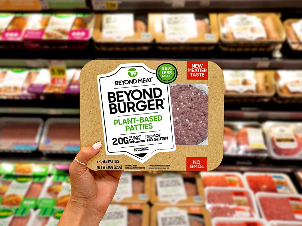 A supermarket shopper holds up a packet of Beyond Meat's meat-free burgers.