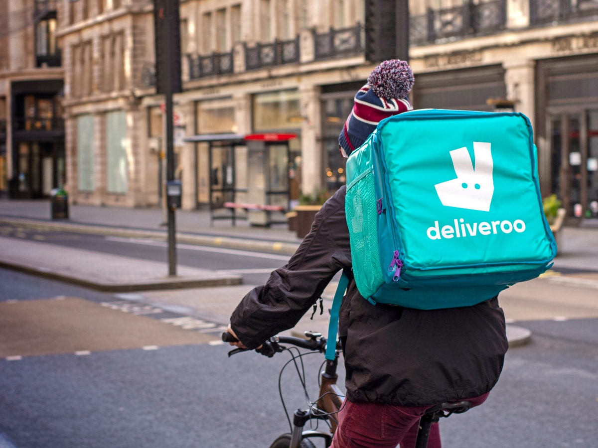 Deliveroo share price: Deliveroo rider with food carrier bag with Deliveroo logo on the back