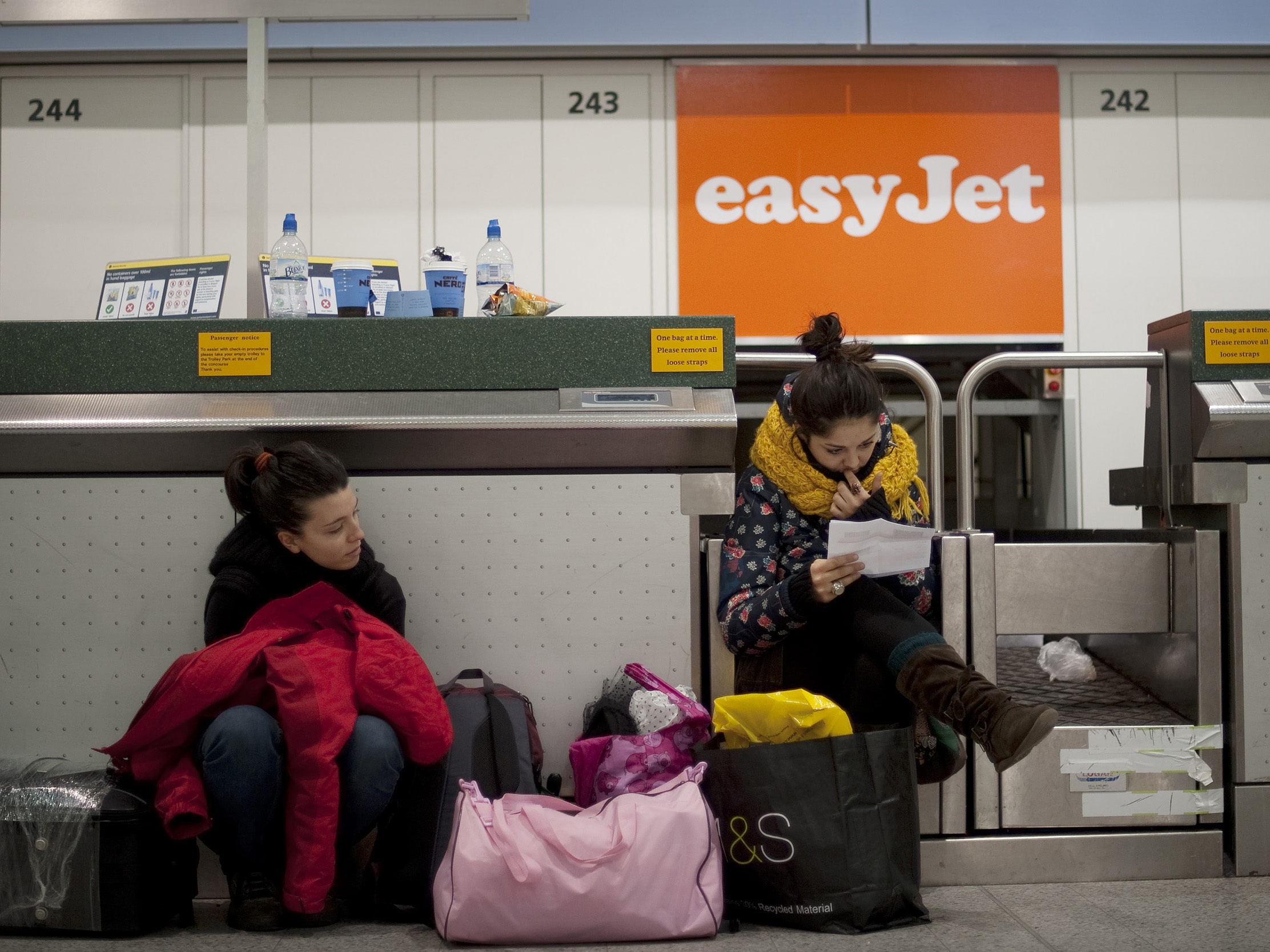 People waiting at an easyJet airport counter