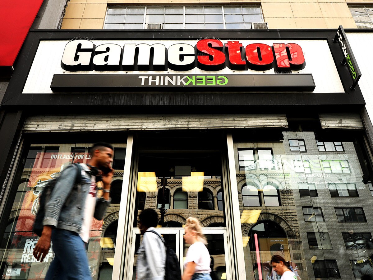 GameStop share price: pedestrians walk past a branch of GameStop.