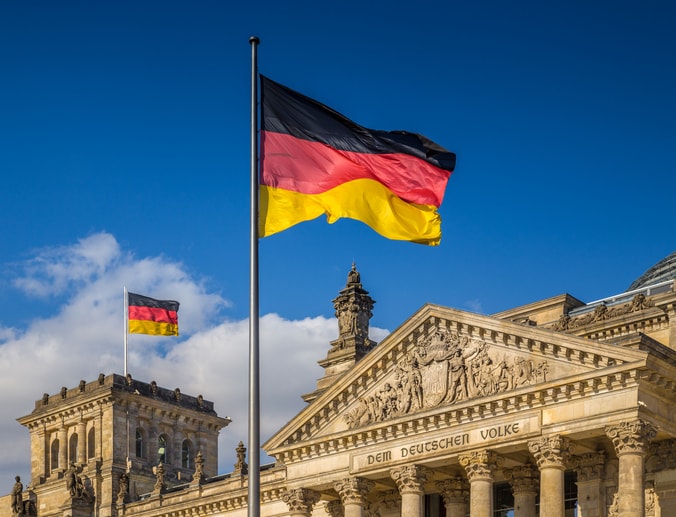 German flags flies above the Bundestag, Germany's parliament building.