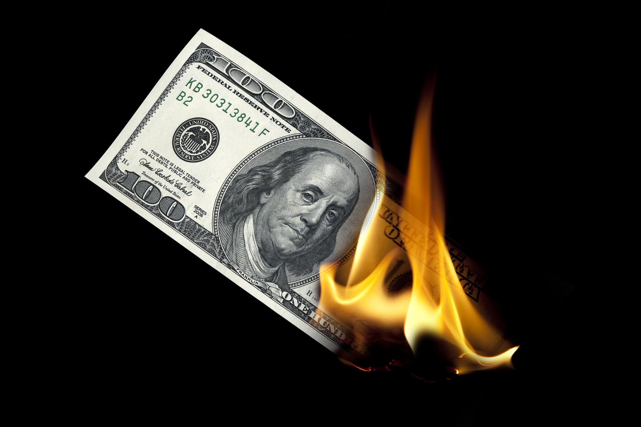A US dollar bill on fire