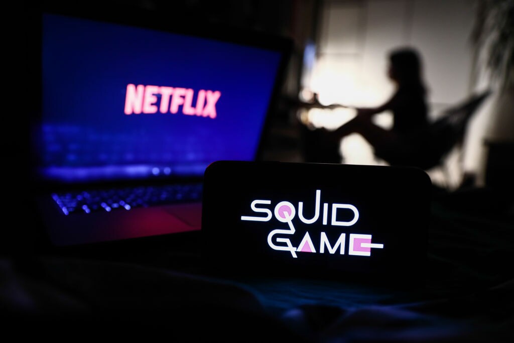 Netflix share price: the Netflix and Squid Game logos appear on separate devices