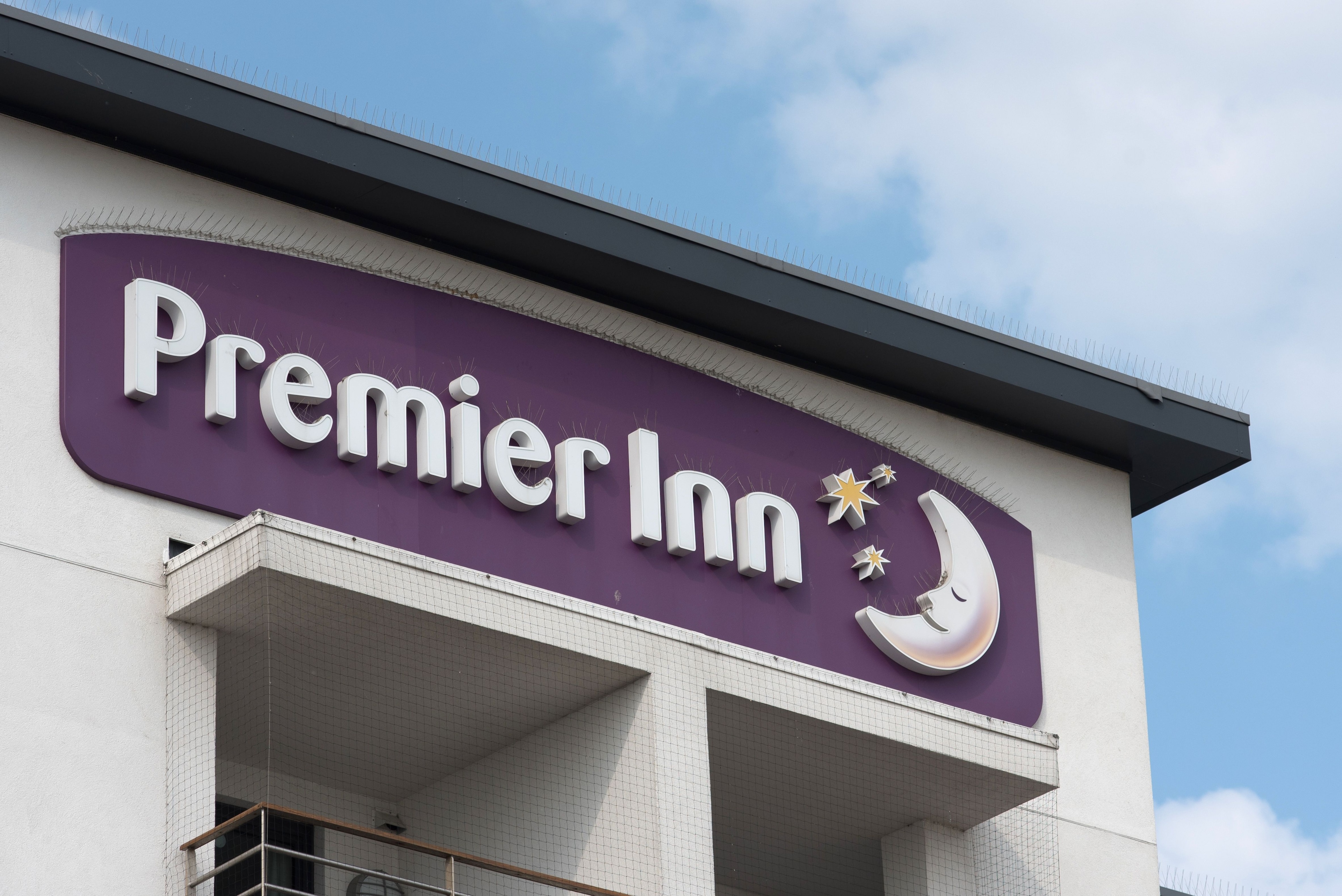 A Premier Inn logo above one of its hotels