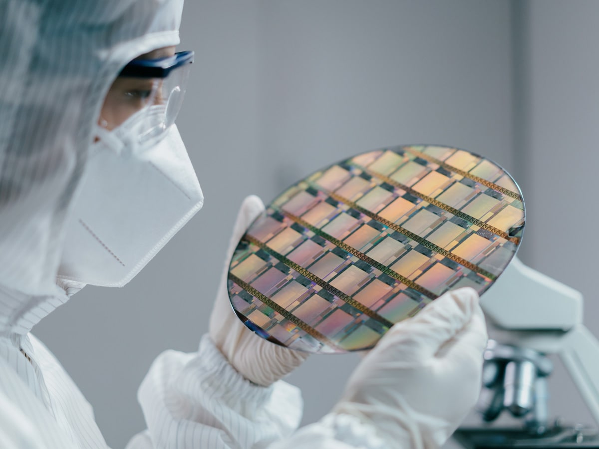 A scientist looking at a semiconductor chip