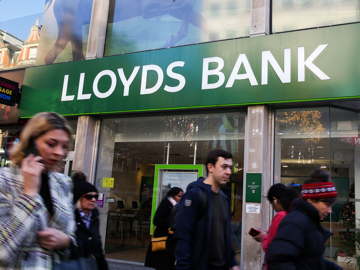 Lloyds Banking Group share price: Pedestrians walk past a branch of Lloyds Bank.