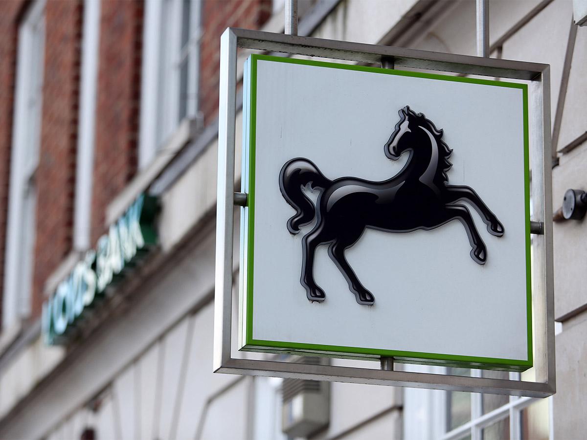 Lloyds share price: A square Lloyds Bank sign with prancing horse logo outside one of the bank's branches