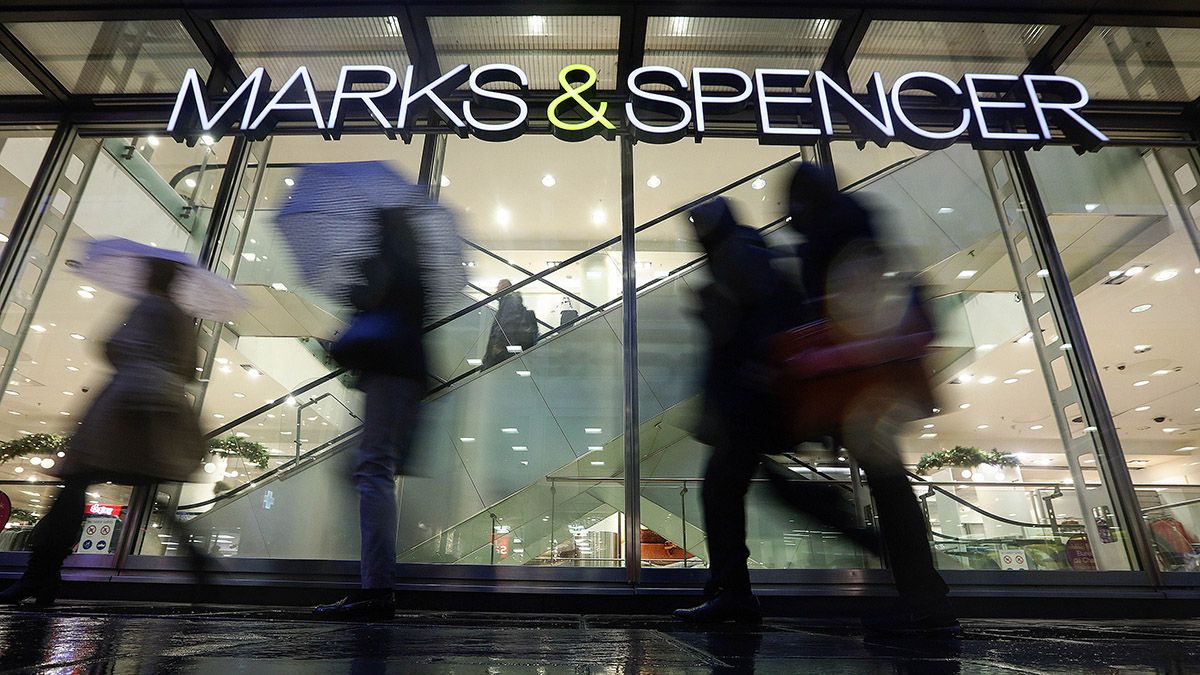 Marks & Spencer share price: people walk past a branch of M&S