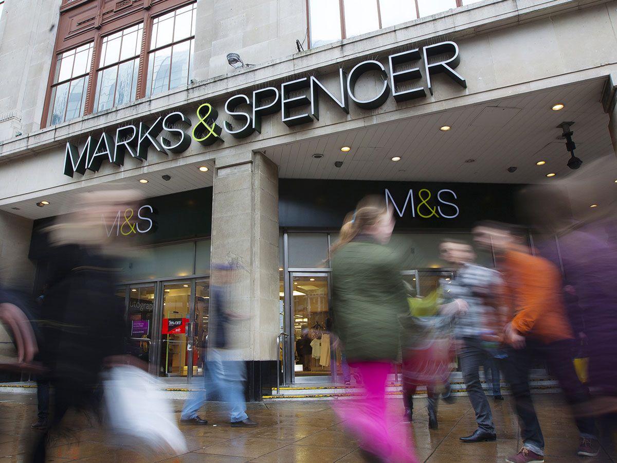 Marks & Spencer share price: shoppers walk past an M&S store