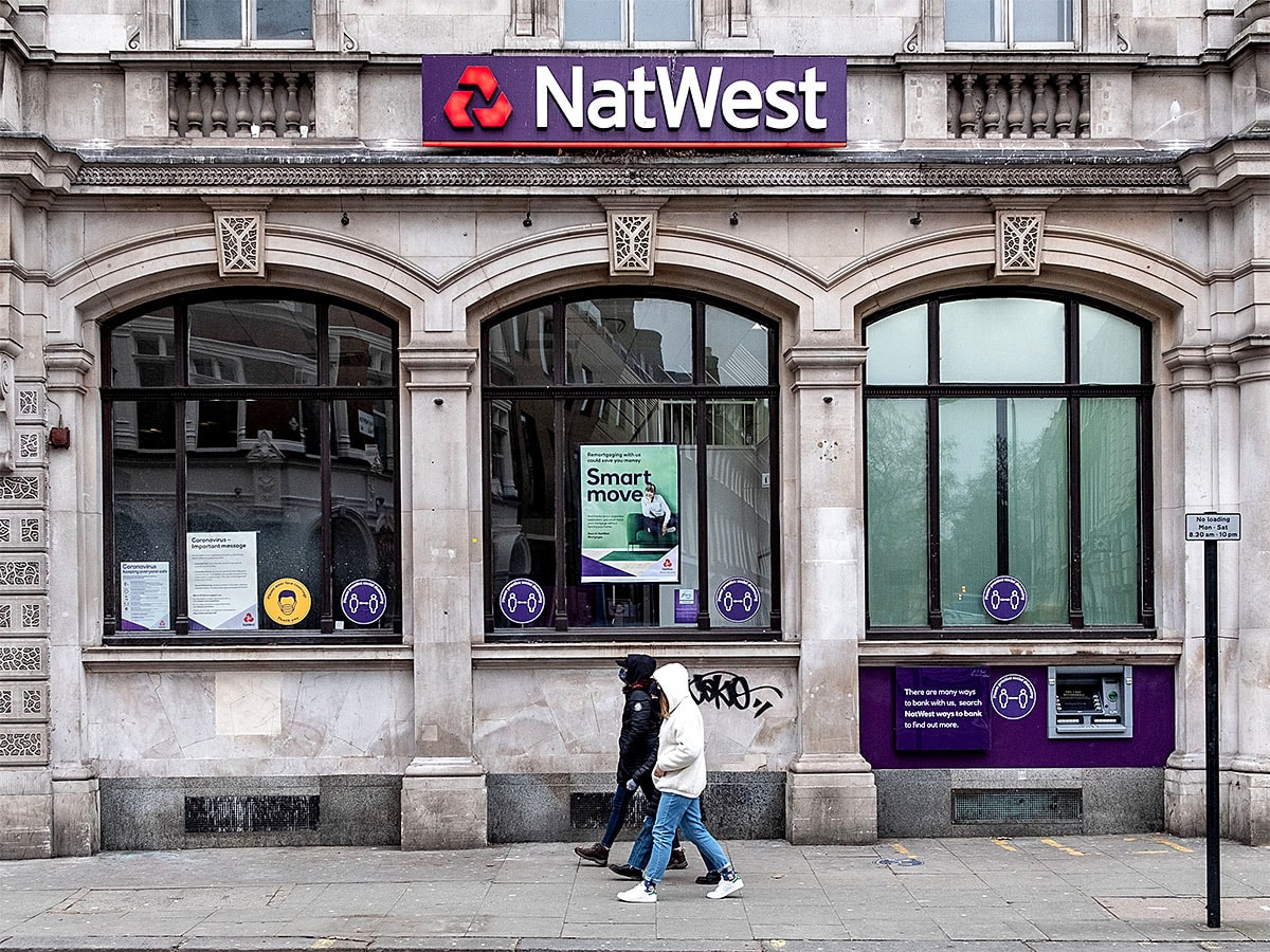 People walking past a NatWest Bank branch