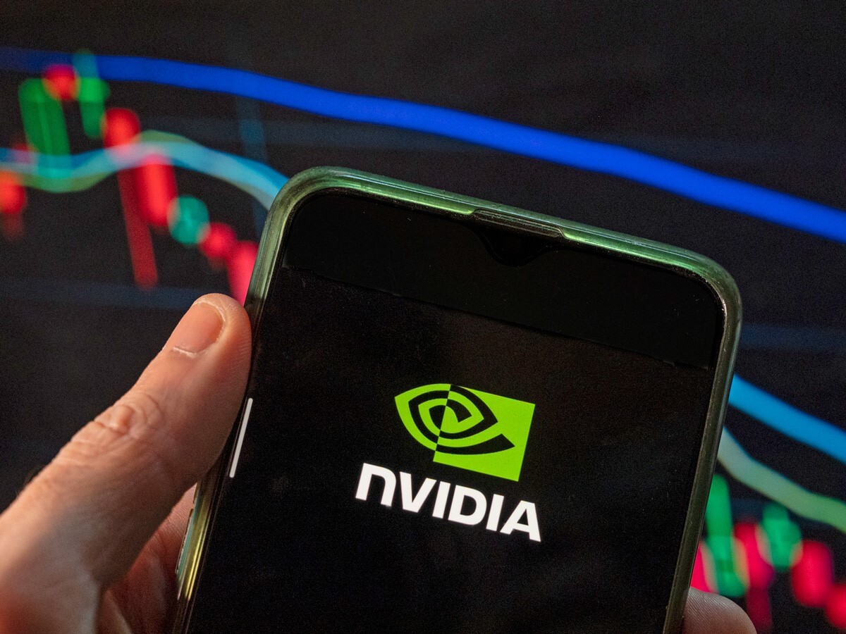 Nvidia share price: image shows the green Nvidia logo on a mobile phone screen in front of a stock price chart.