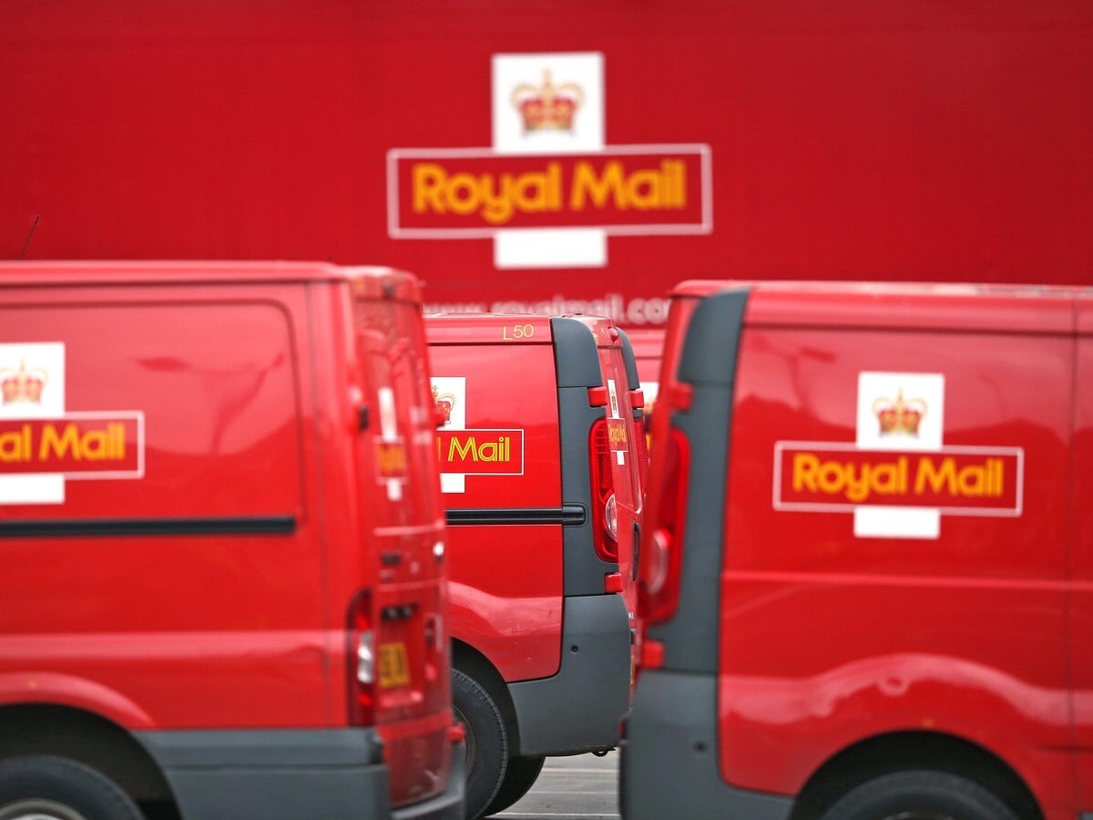 Royal Mail share price: delivery vans line up outside a distribution centre.