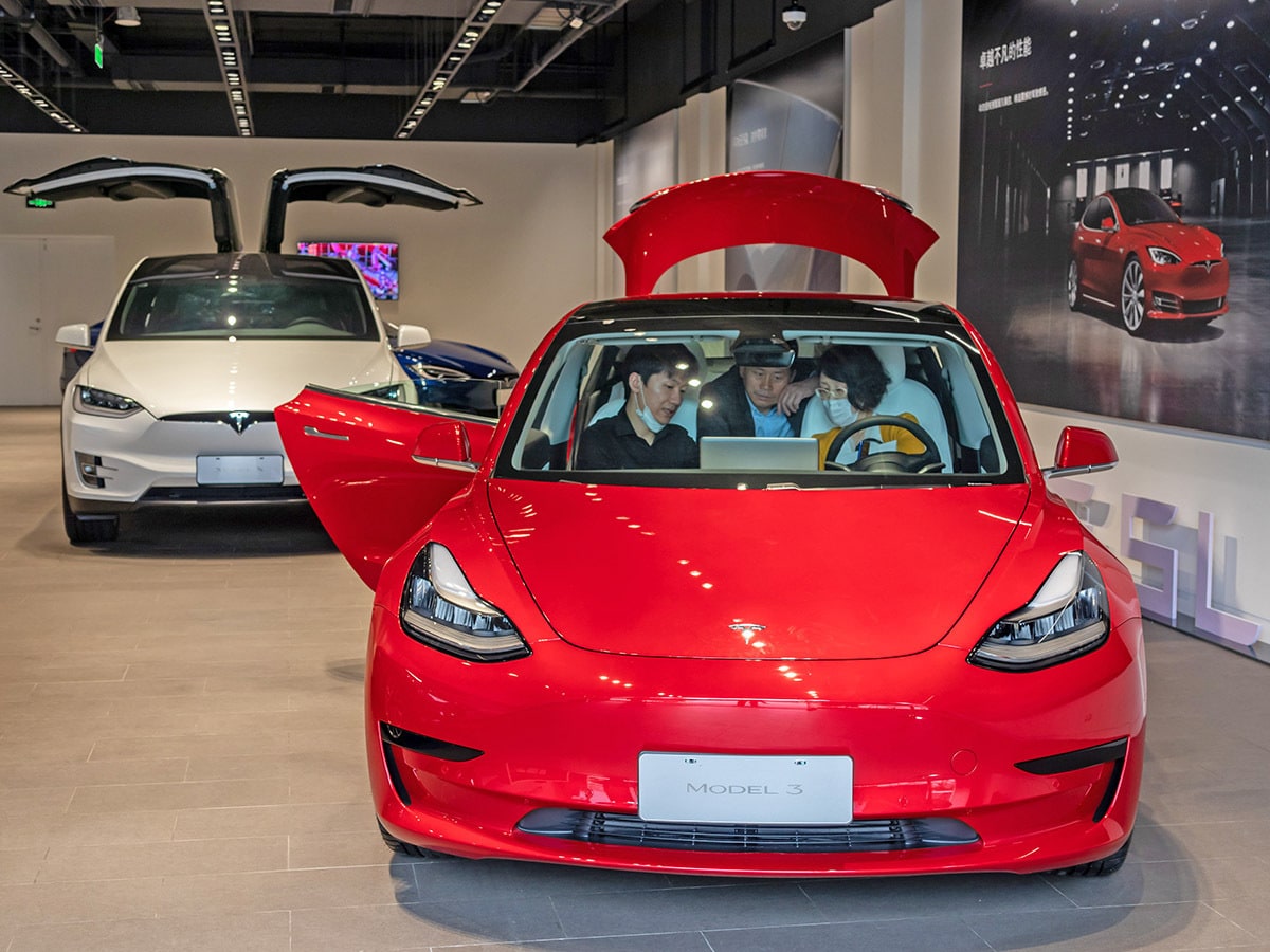 Two Tesla vehicles in a showroom.
