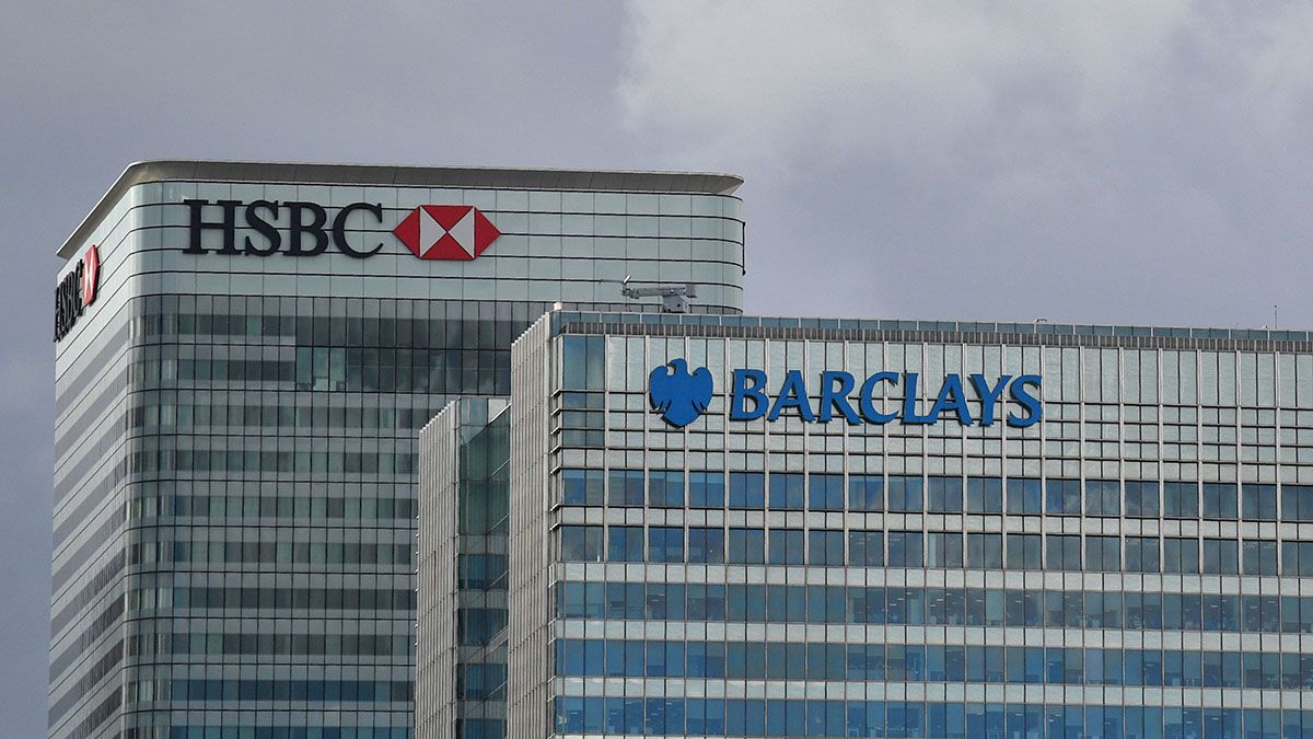 Skyscrapers at London's Canary Wharf show the logos of HSBC and Barclays.