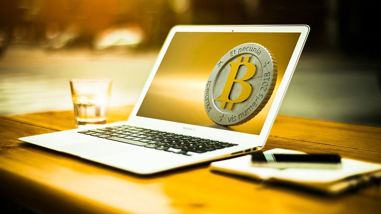 The bitcoin logo displayed on a laptop