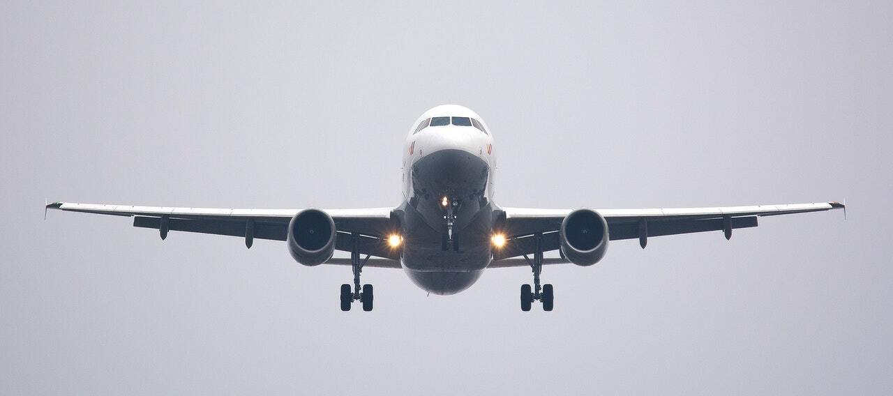 plane in the sky after taking off from runway