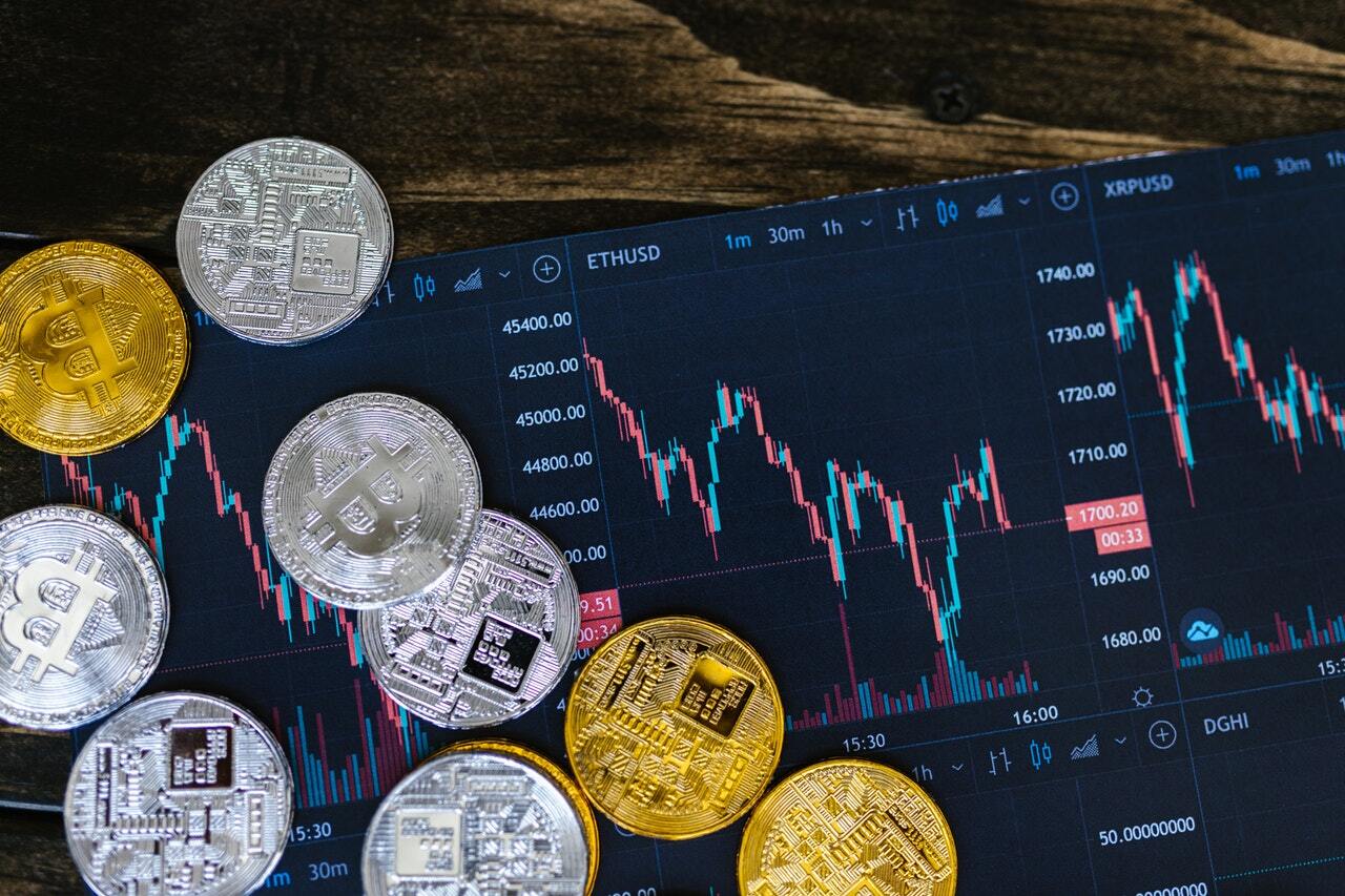 cryptocurrencies and a computer screen with a financial chart showing