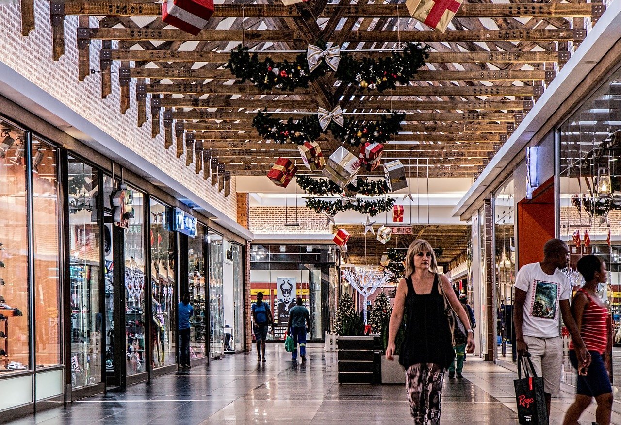 people shopping at a mall decorated for Christmas