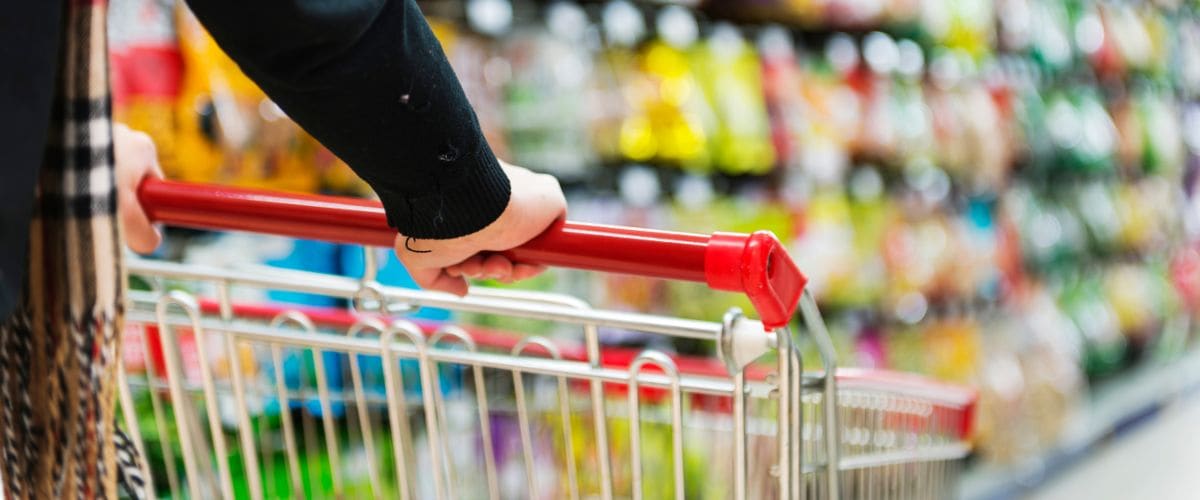 Shopper pushing a supermarket trolley