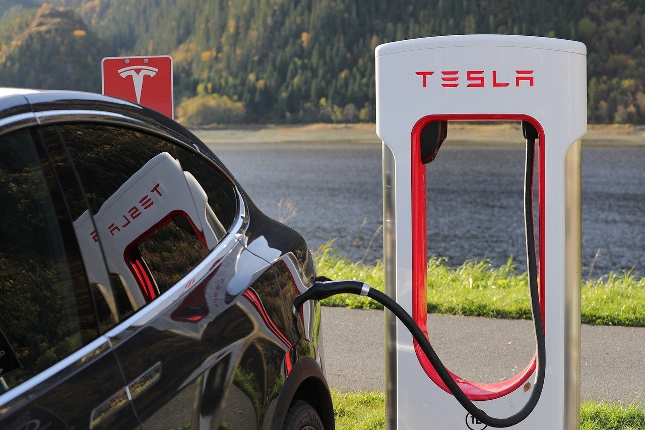 Tesla car recharging at battery station