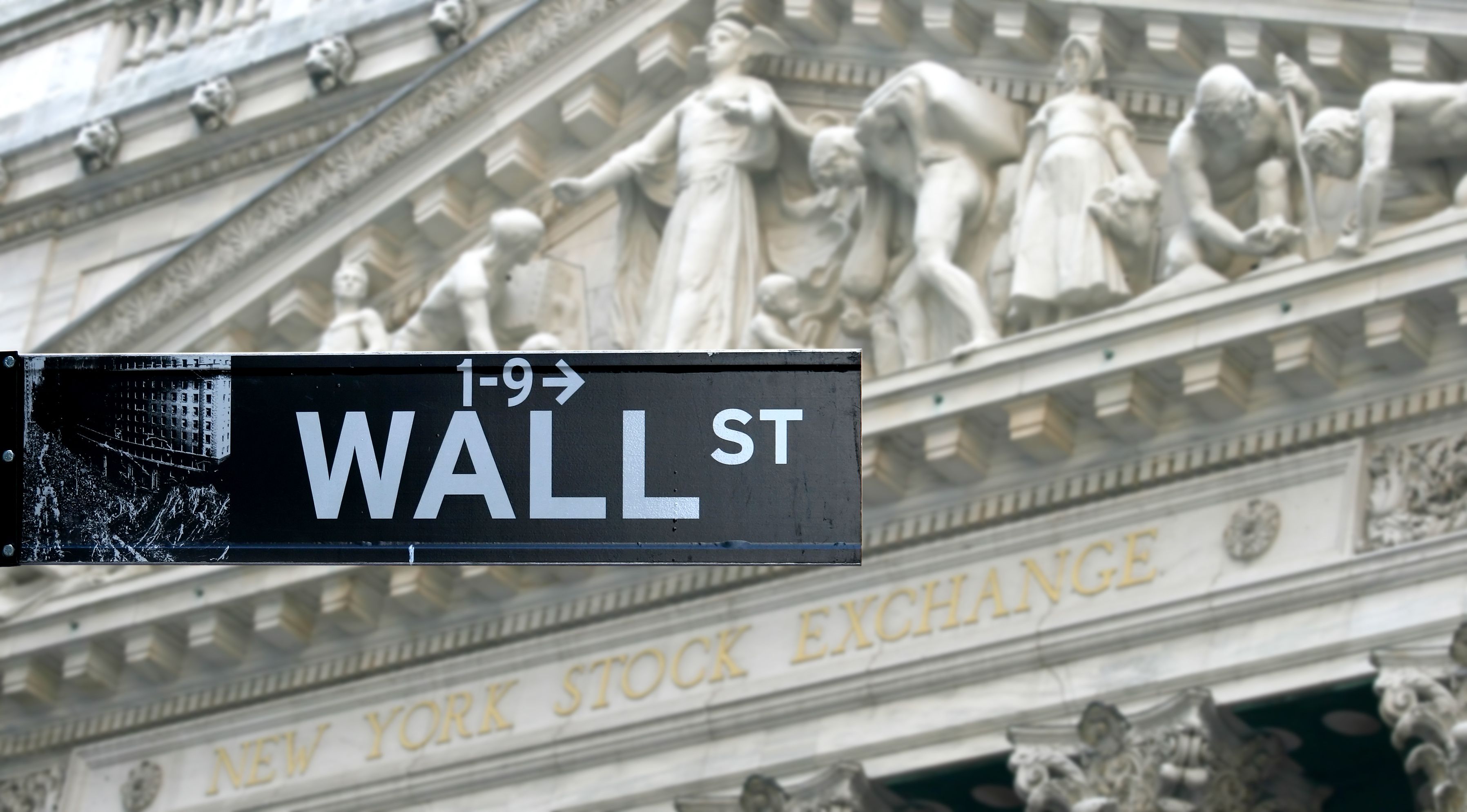 Article image shows a road sign on New York's Wall Street.